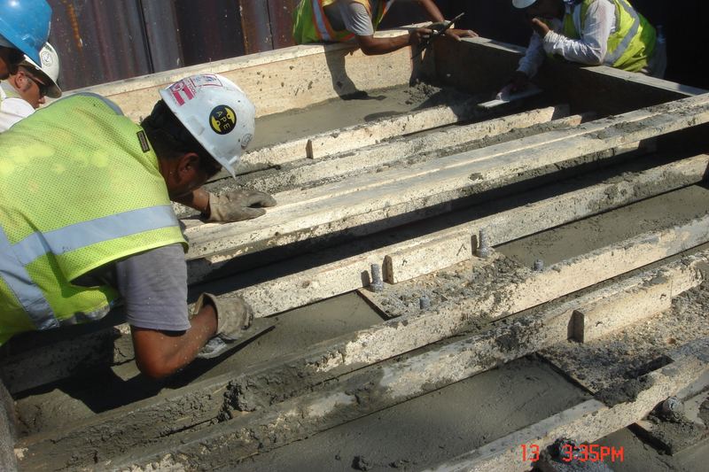 Concrete being poured for the two footings at the north bridge abutment.